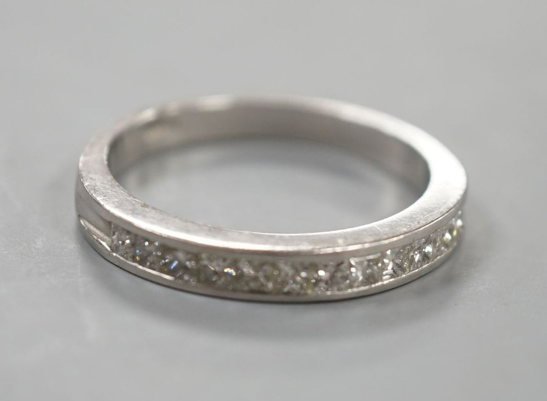 A platinum and twelve stone diamond set half eternity ring, size R, gross weight 6.4 grams.